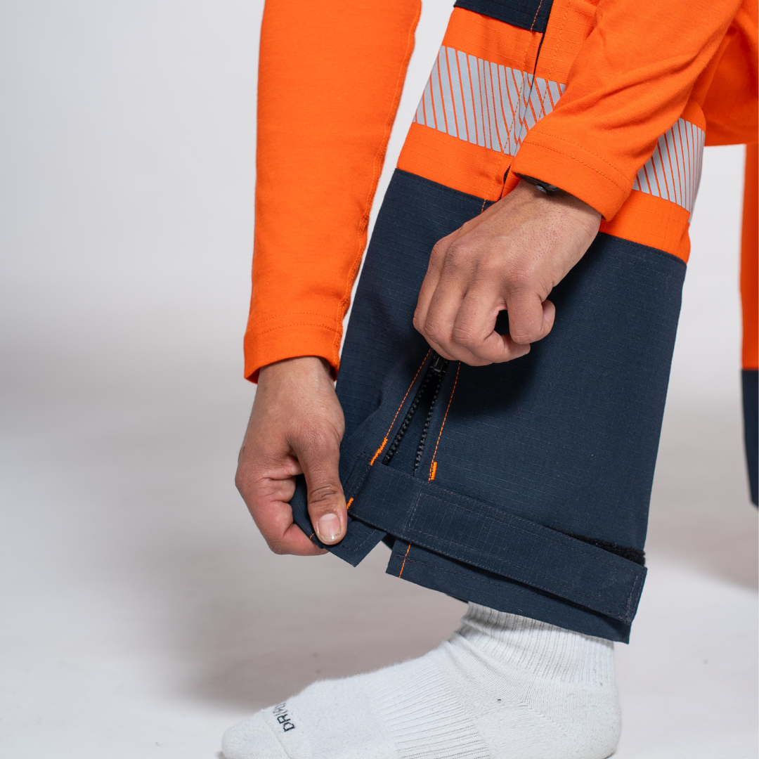 MWG STORMSHIELD Women's FR Rain Pant. Women's FR Rain Pant is bright orange and navy with silver reflective striping. Women's FR Rain Pant is CAT 2 FR.