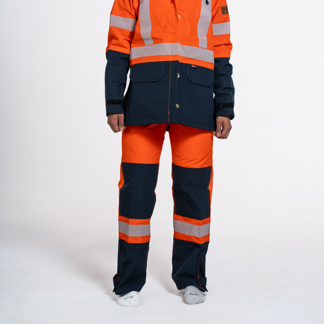 MWG STORMSHIELD Women's FR Rain Pant. Women's FR Rain Pant is bright orange and navy with silver reflective striping. Women's FR Rain Pant is CAT 2 FR.