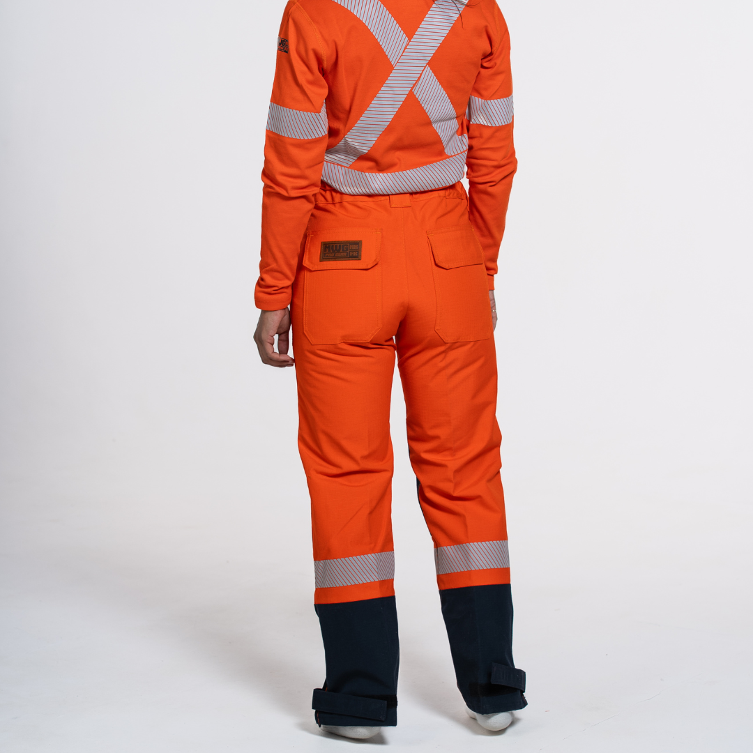MWG STORMSHIELD Women's FR Rain Pant. Women's FR Rain Pant is bright orange and navy with silver reflective striping. Women's FR Rain Pant is CAT 2 FR.