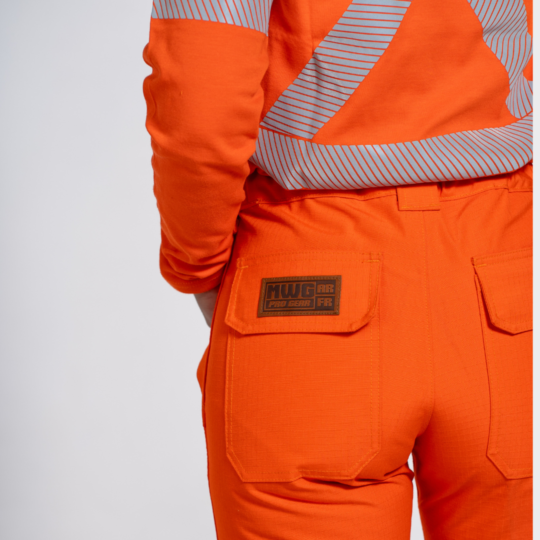 MWG STORMSHIELD Women's FR Rain Pant. Women's FR Rain Pant is bright orange and navy with silver reflective striping. Women's FR Rain Pant is CAT 2 FR.