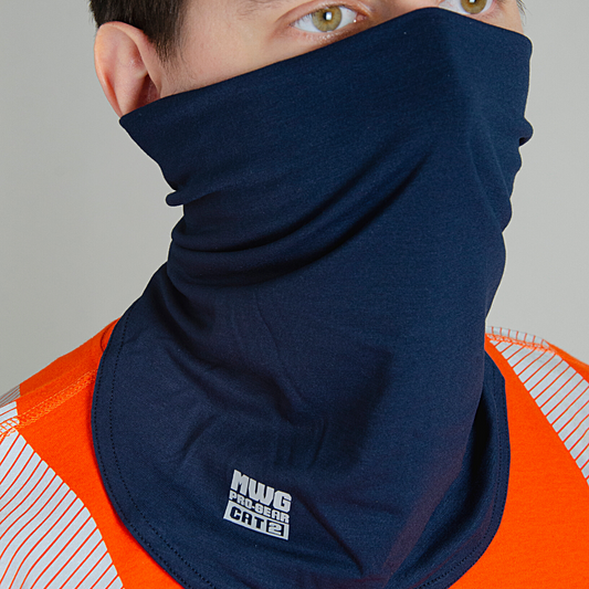 Image of MWG FLEXSAFE FR Neck Gaiter. Flame-resistant (FR) gaiter is navy in colour with silver MWG Pro Gear logo and CAT 2 identification. MWG FLEXSAFE is an inherent flame-resistant fabric. Model is wearing FR gaiter with orange MWG EVOLUTION FR Shirt.