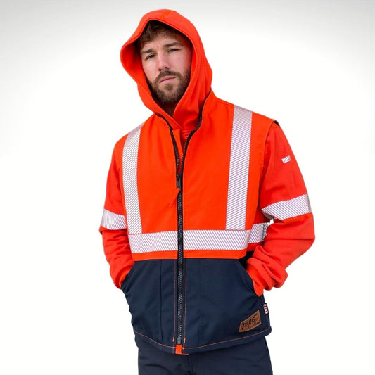 MWG STORMSHIELD Men's FR Vest. Men's FR Vest is orange and navy with silver segmented reflective striping for high-visibility. FR Vest has a black FR Zipper on front with a brown MWG logo. FR Vest is made with MWG STORMSHIELD, a waterproof and windproof FR fabric. Men's FR Vest is worn over an MWG BLOCKER FR Hoodie. Men's FR Vest has a CAT 2 FR rating.