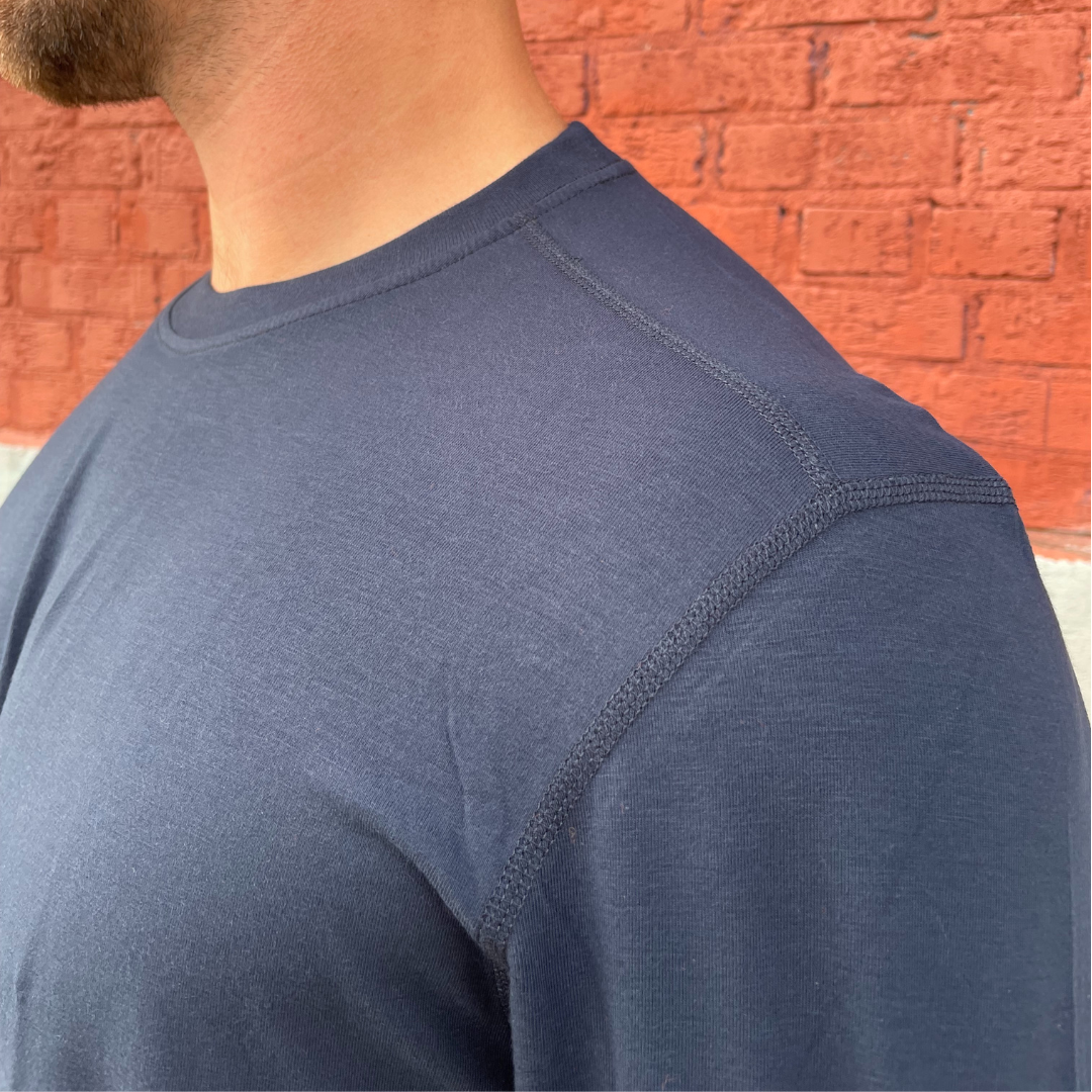 MWG FLEXSAFE Men's FR Long-Sleeve T-Shirt. Men's FR Base Layer Shirt is navy. Men's FR Base Layer Long-Sleeve is made with MWG FLEXSAFE, an inherent flame-resistant fabric. MWG FLEXSAFE is a moisture-wicking, 4-way stretch fabric. FR Base Layer shirt has CAT 1 FR rating.