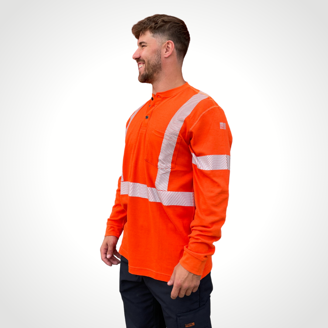 MWG EVOLUTION Men's FR Henley. Men's FR Henley is bright orange with silver segmented reflective tape on torso and sleeves for high-visibility. Men's FR Shirt has 3 black FR buttons on collar and a left chest pocket. FR Shirt is made with MWG EVOLUTION, a lightweight inherently flame-resistant fabric. Men's FR Shirt has a CAT 2 FR rating.