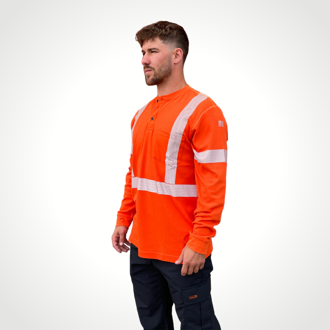 MWG EVOLUTION Men's FR Henley. Men's FR Henley is bright orange with silver segmented reflective tape on torso and sleeves for high-visibility. Men's FR Shirt has 3 black FR buttons on collar and a left chest pocket. FR Shirt is made with MWG EVOLUTION, a lightweight inherently flame-resistant fabric. Men's FR Shirt has a CAT 2 FR rating.