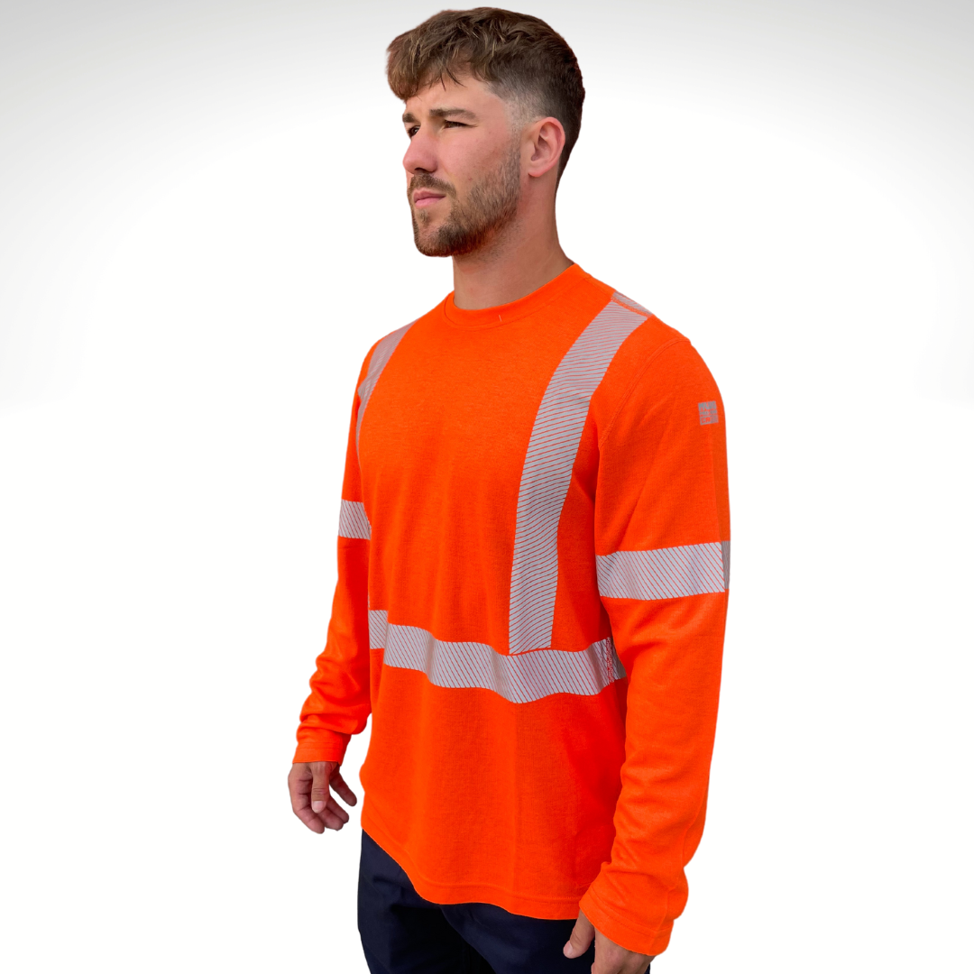 Image of MWG TRANSMISSION FR long-sleeve t-shirt in bright orange. MWG TRANSMISSION FR long-sleeve shirt is made with inherent FR fabric that is bright orange in colour with silver segmented reflective tape to meet CSA Z96-15 high-visibility standard. MWG TRANSMISSION is designed for workers in electrical utilities and mining