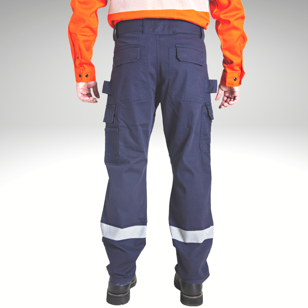 Back view of MWG FLEXGUARD Men's Stretch Canvas FR Utility Pant. Image displays two large back pockets with flaps, side cargo pockets, tool loops on hips, and silver segmented reflective tape on lower legs. FR Pants are navy in colour.