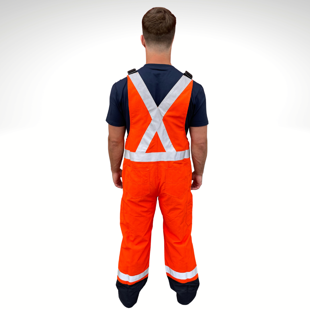 MWG RIPGUARD Men's FR Bib Overall. Men's FR Overall is bright orange and navy with silver reflective striping on torso and legs for high-visibility. FR Overalls have two chest pockets with flaps, two FR leg zippers, and a front FR zipper. FR Overalls have black FR adjustable shoulder straps. FR Overalls are made with MWG RIPGUARD, a flame-resistant ripstop fabric. FR Overalls have a CAT 2 FR rating.