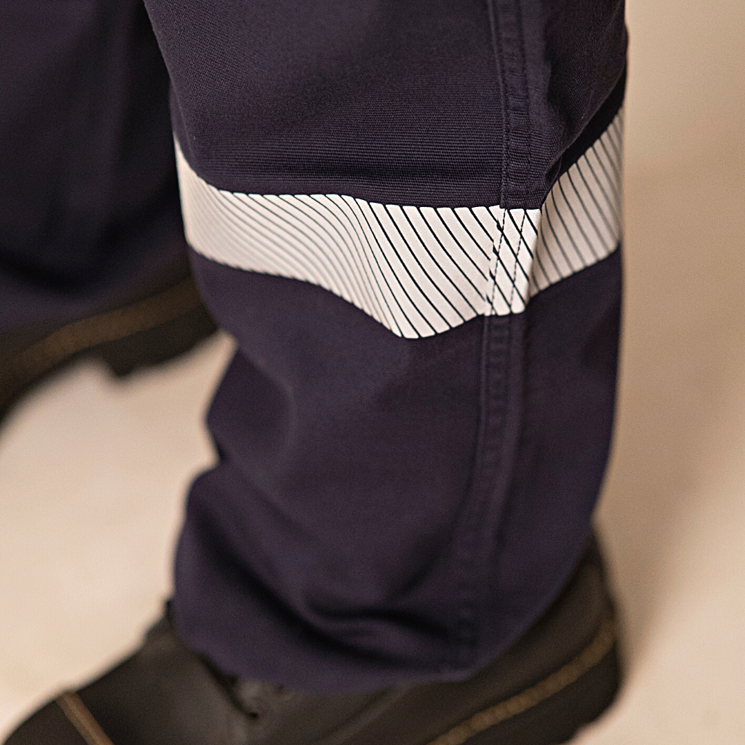 Close up image of silver segmented reflective striping on lower leg of MWG COMFORT WEAVE Women's FR Cargo Pant. Silver segmented reflective striping is used for visibility. Heat-sealed for lightweight and less bulk.