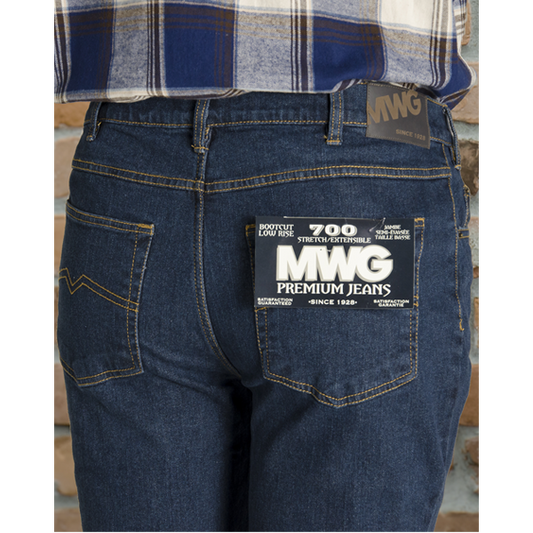 Image of MWG Jeans. MWG Premium Stretch Bootcut Jeans are dark blue in colour with gold stitching. Brown leather MWG label is seen on waistband.