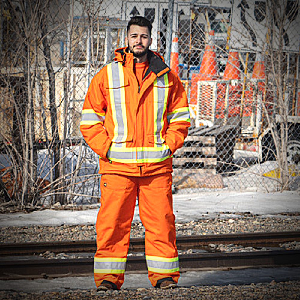 Image of Hi-Vis Cotton Duck Insulated Parka. Hi-Vis parka is bright orange in colour with yellow/silver/yellow reflective on arms and torso to meet high-visibility standard CSA Z96-15. Parka comes with detachable hood. Parka has 4 large front pockets seen in image.