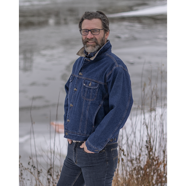 Image of MWG Storm Rider Lined Denim Jacket. MWG jean jacket is navy in colour with gold stitching and a tan corduroy collar. Model is wearing the collar up. Model is wearing Storm Rider Lined Denim Jacket with MWG stretch denim blue jeans.
