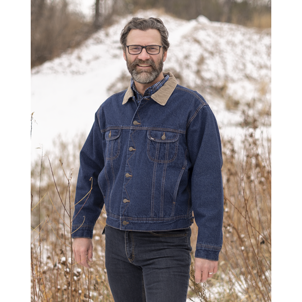 Image of MWG Storm Rider Lined Jean Jacket. MWG Denim Jacket is navy in colour. Jean jacket has a tan corduroy collar. Buttons are gold as well as the stitching. Model is wearing MWG Storm Rider Jacket with MWG stretch denim blue jeans.