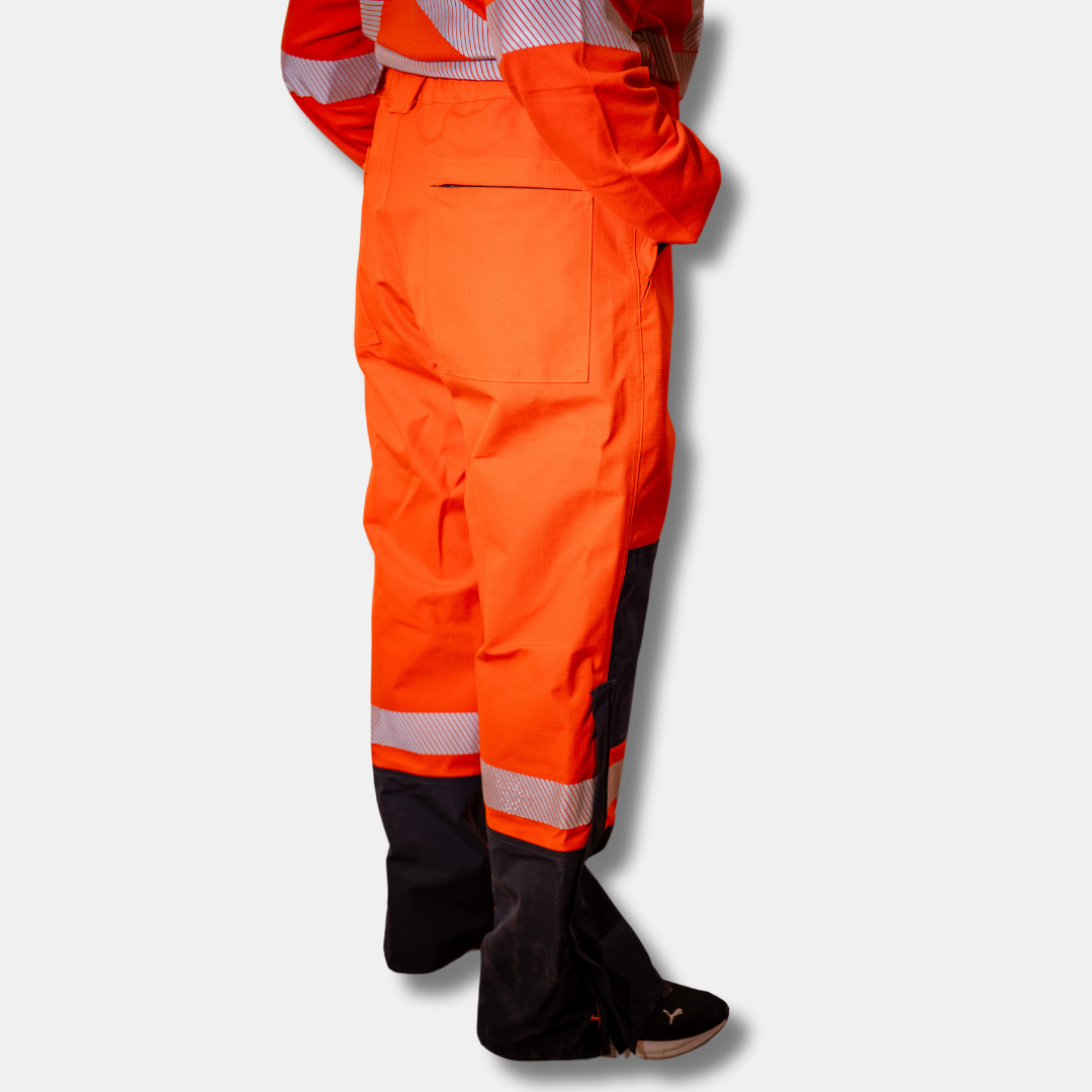 MWG STORMSHIELD Women's FR Rain Pant. Women's FR Rain Pants are bright orange and navy with silver reflective on lower leg.