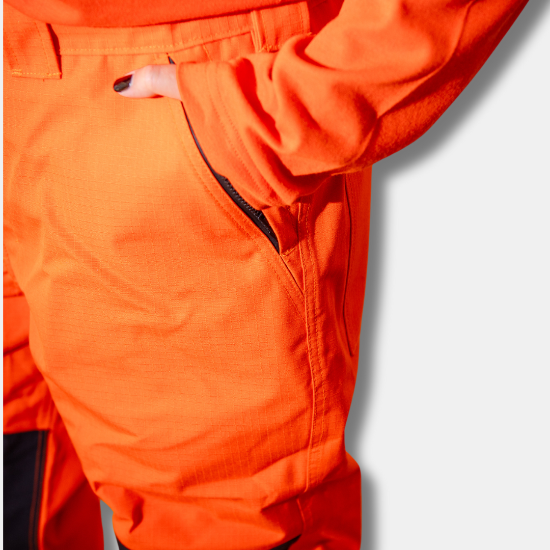 MWG STORMSHIELD Women's FR Rain Pant. Women's FR Rain Pants are bright orange and navy with silver reflective on lower leg.