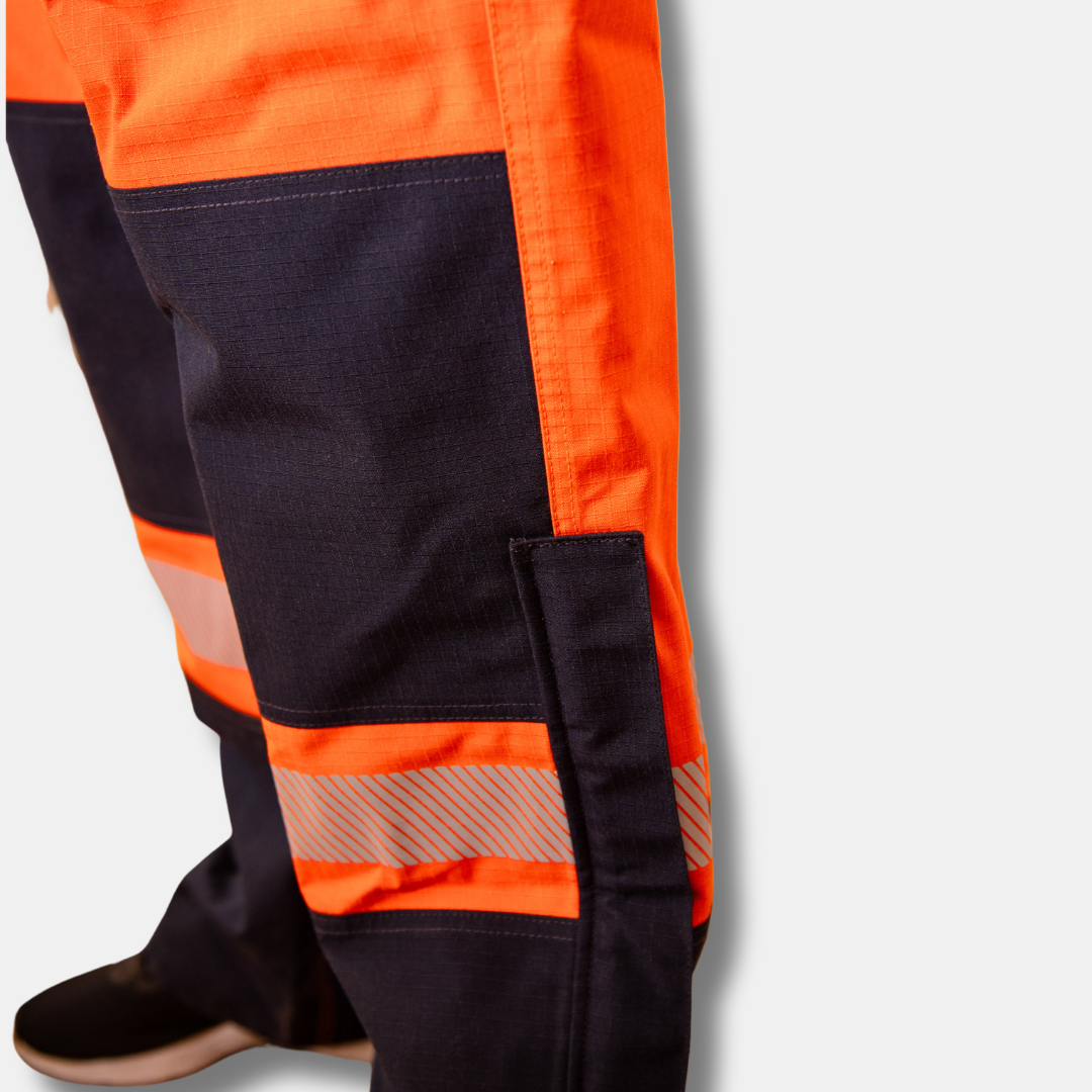 MWG STORMSHIELD Women's FR Rain Pant. Women's FR Rain Pants are bright orange and navy with silver reflective on lower leg.