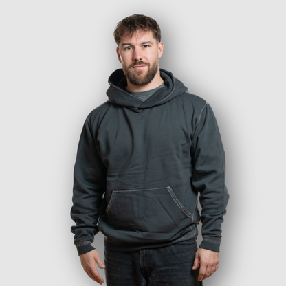 Man wearing a dark gray hoodie against a plain background