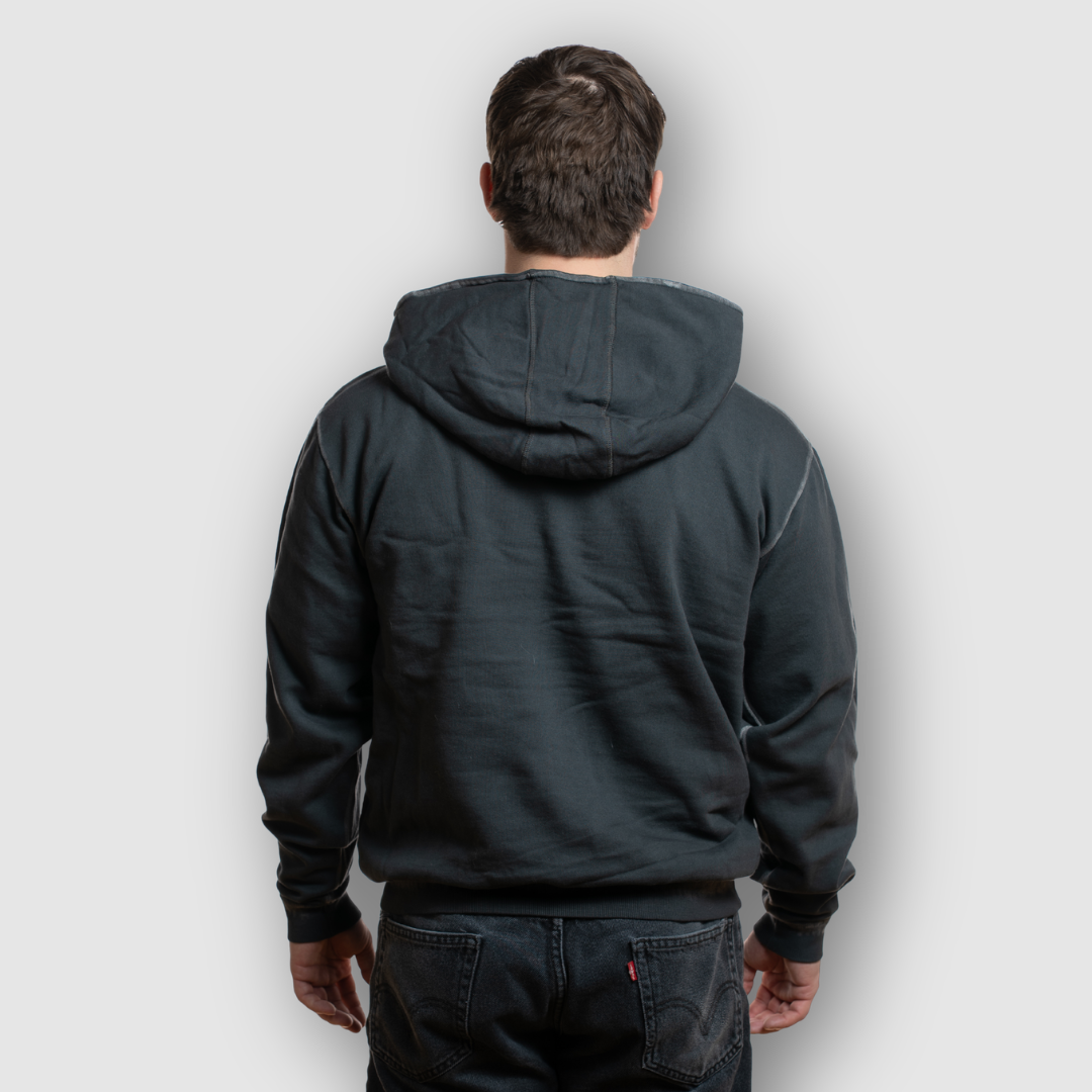 Person wearing a black hoodie from behind on a light gray background
