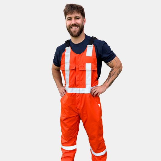 MWG lightweight bib overall. FR Bib Overall is bright orange in colour with silver reflective tape on torso and legs.