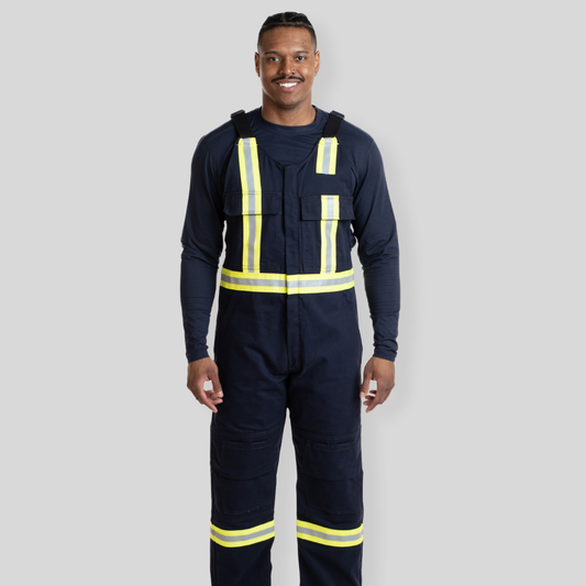 Man wearing navy hi-vis bib overalls from MWG Apparel