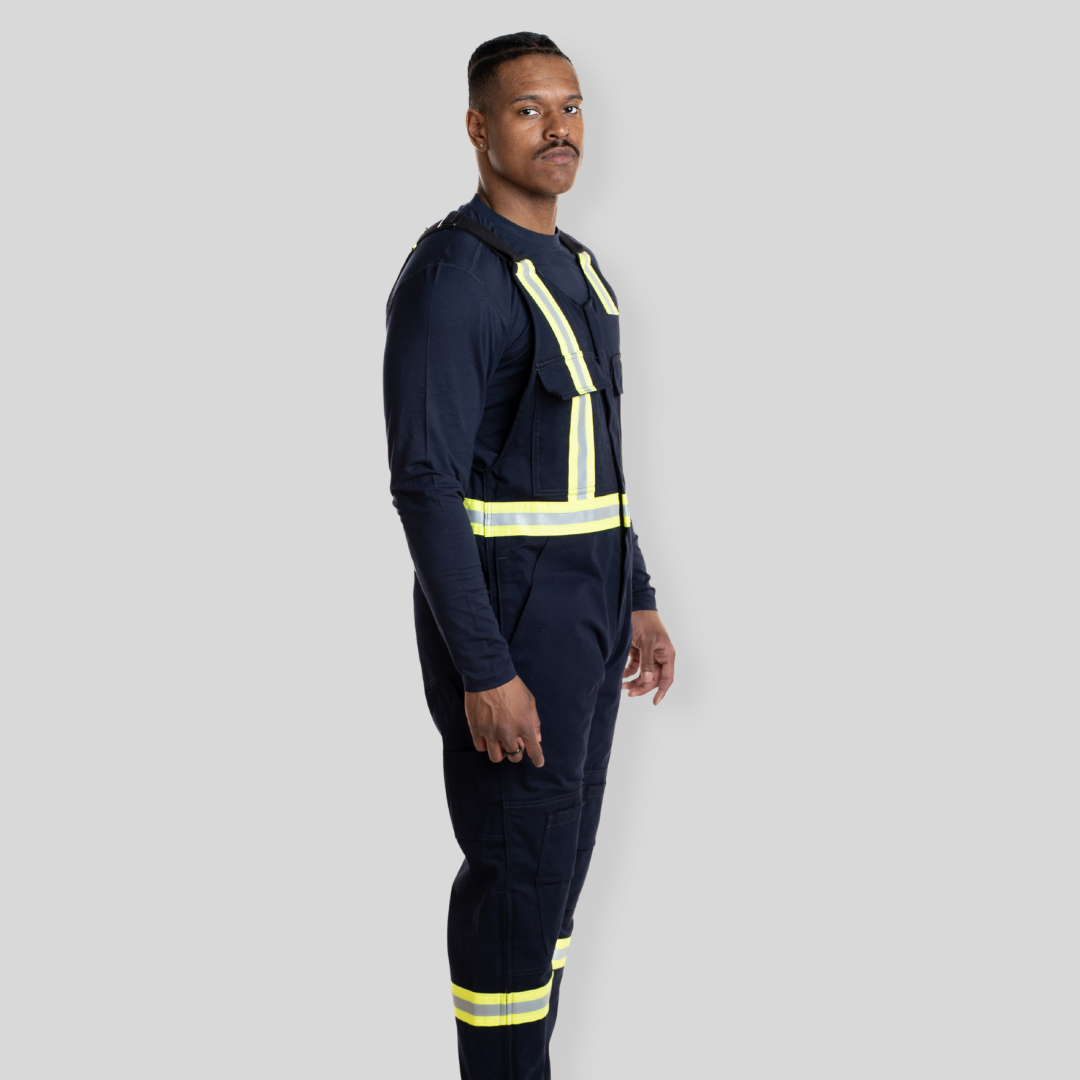 Man wearing navy hi-vis bib overalls from MWG Apparel