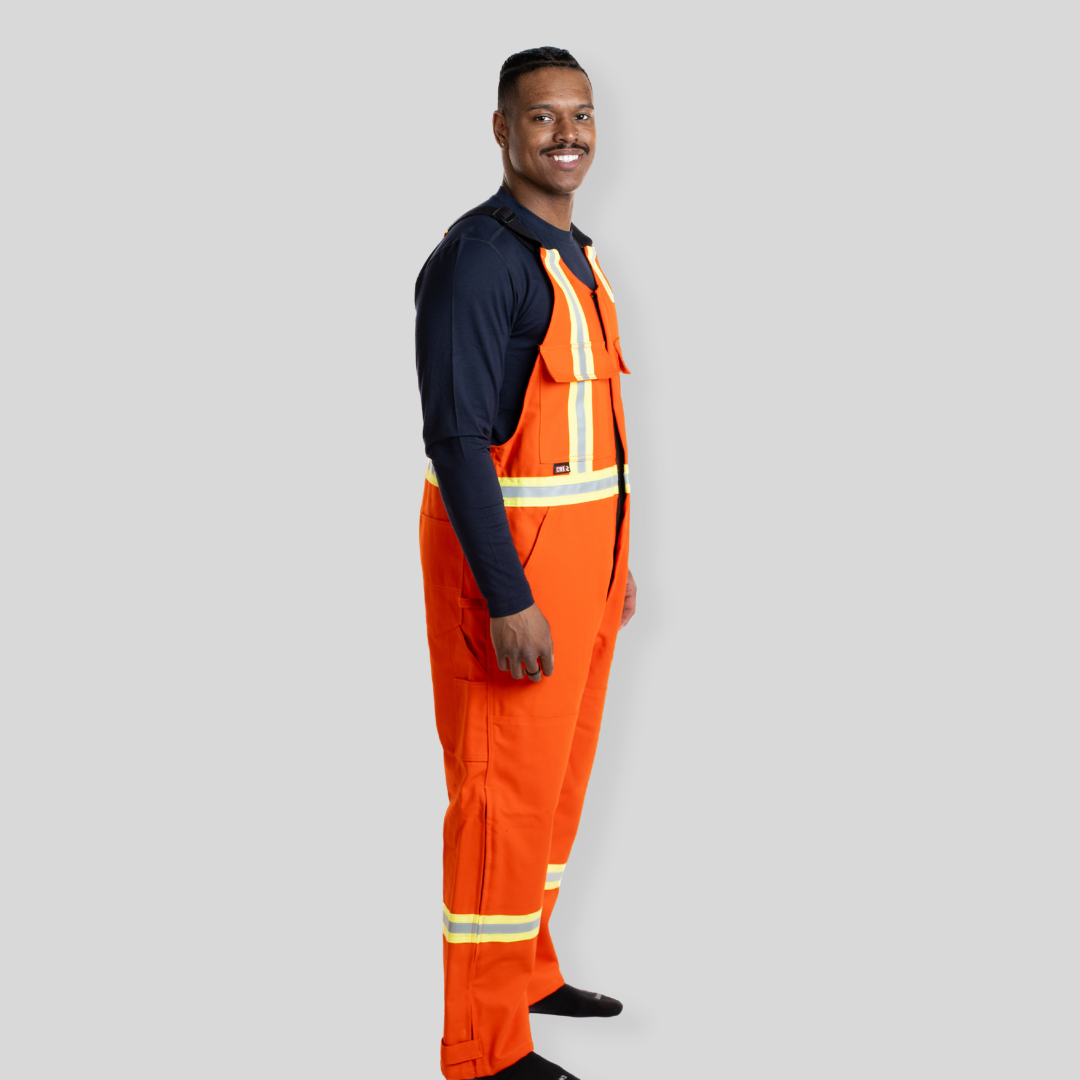 Man wearing orange FR Overalls. FR Overalls made for Welding. Heavyweight FR Canvas.