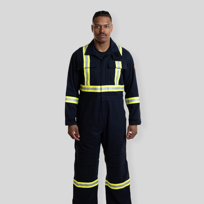 Man wearing navy coveralls with reflective striping. Navy hi-vis coveralls made from 100% cotton.