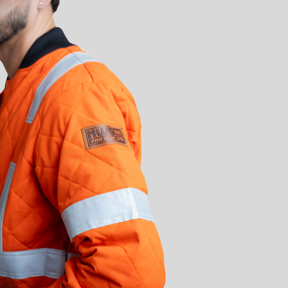Men's FR Quilted Jacket. Men's FR Jacket is orange with silver reflective. Men's FR Jacket is CAT 4 FR and made with inherently FR fabric.