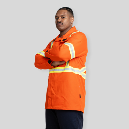 Man wearing FR Welding Jacket. FR Welding Jacket is bright orange with reflective striping for high-visibility.