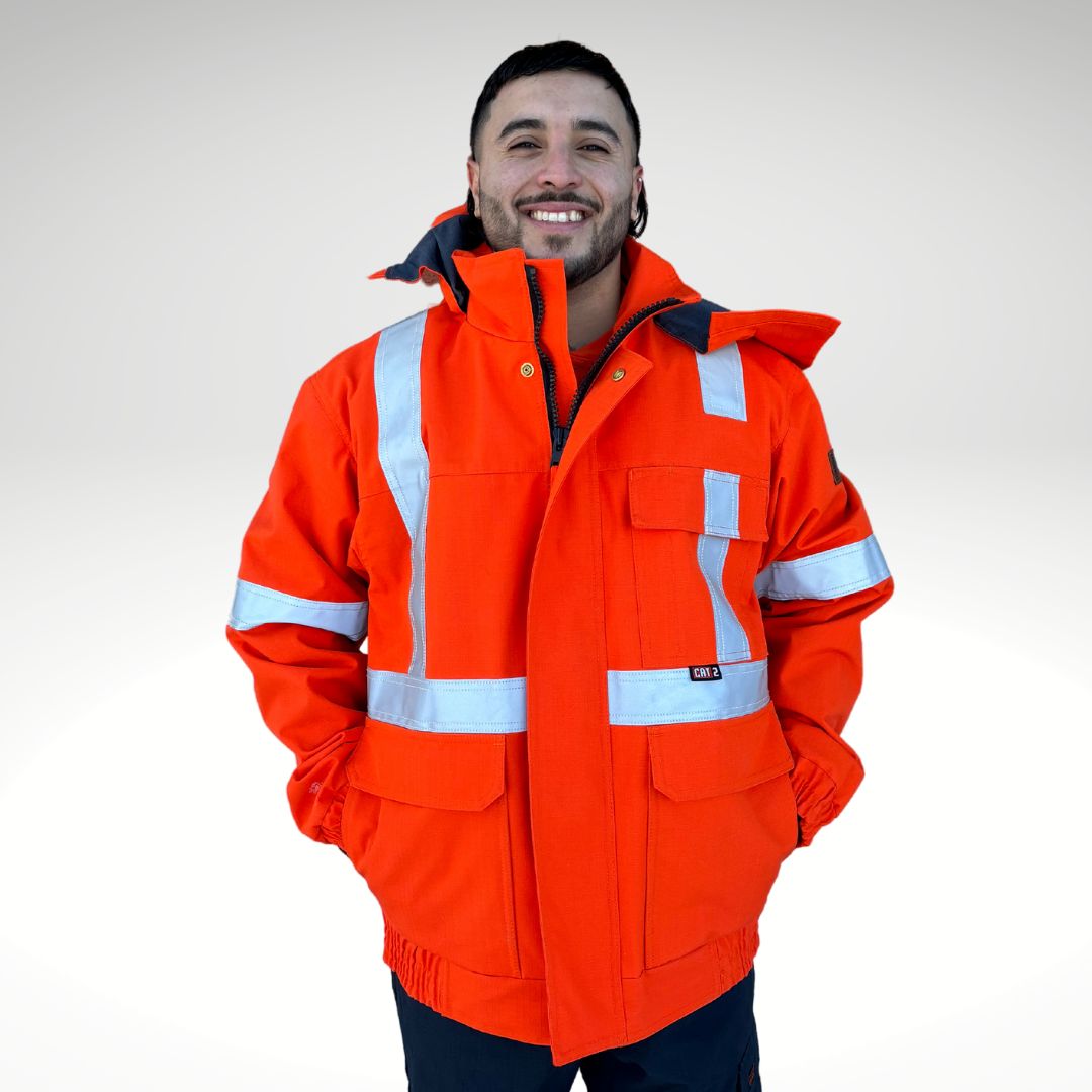 Image of MWG STORMSHIELD FR/AR Bomber Jacket. Arc-Rated Winter Jacket is bright orange with silver reflective tape for high-visibility. MWG STORMSHIELD is an inherent flame-resistant ripstop fabric. MWG STORMSHIELD is waterproof and windproof for warmth and comfort in cold and wet weather. Men's FR Freezer Jacket zips in for added warmth.