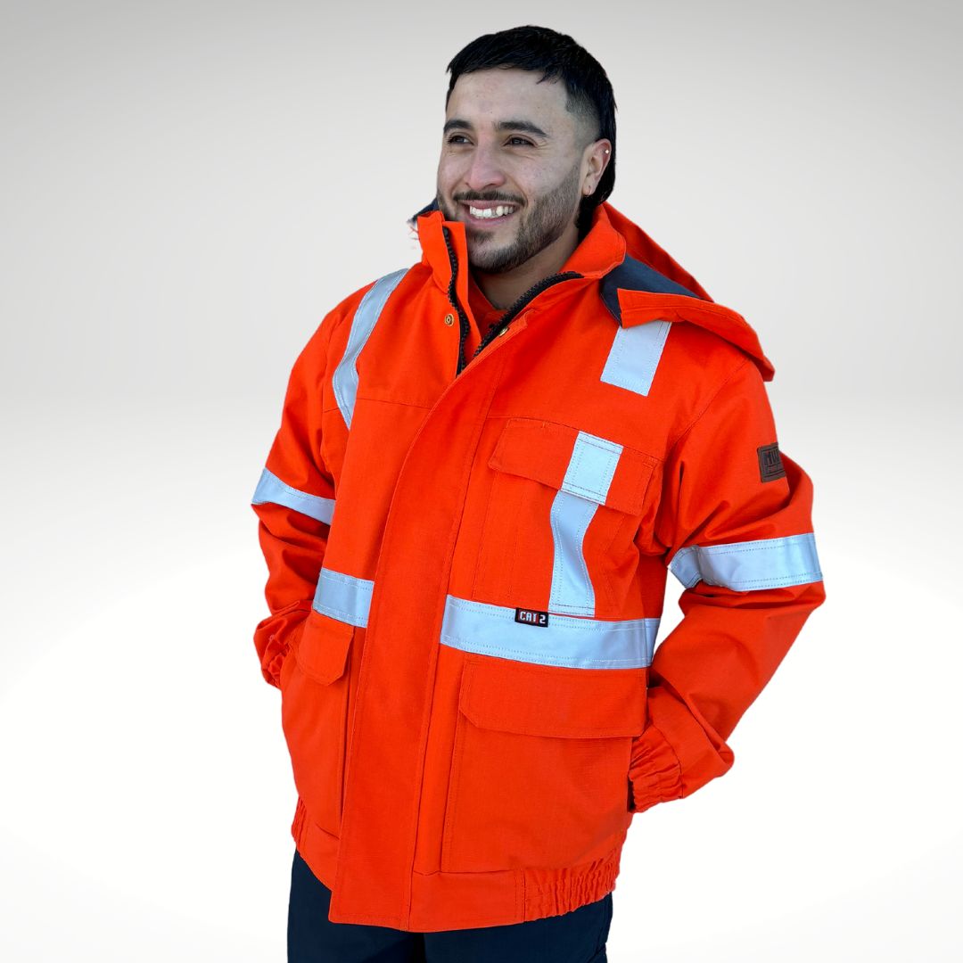 Image of MWG STORMSHIELD FR/AR Bomber Jacket. Arc-Rated Winter Jacket is bright orange with silver reflective tape for high-visibility. MWG STORMSHIELD is an inherent flame-resistant ripstop fabric. MWG STORMSHIELD is waterproof and windproof for warmth and comfort in cold and wet weather. Men's FR Freezer Jacket zips in for added warmth.