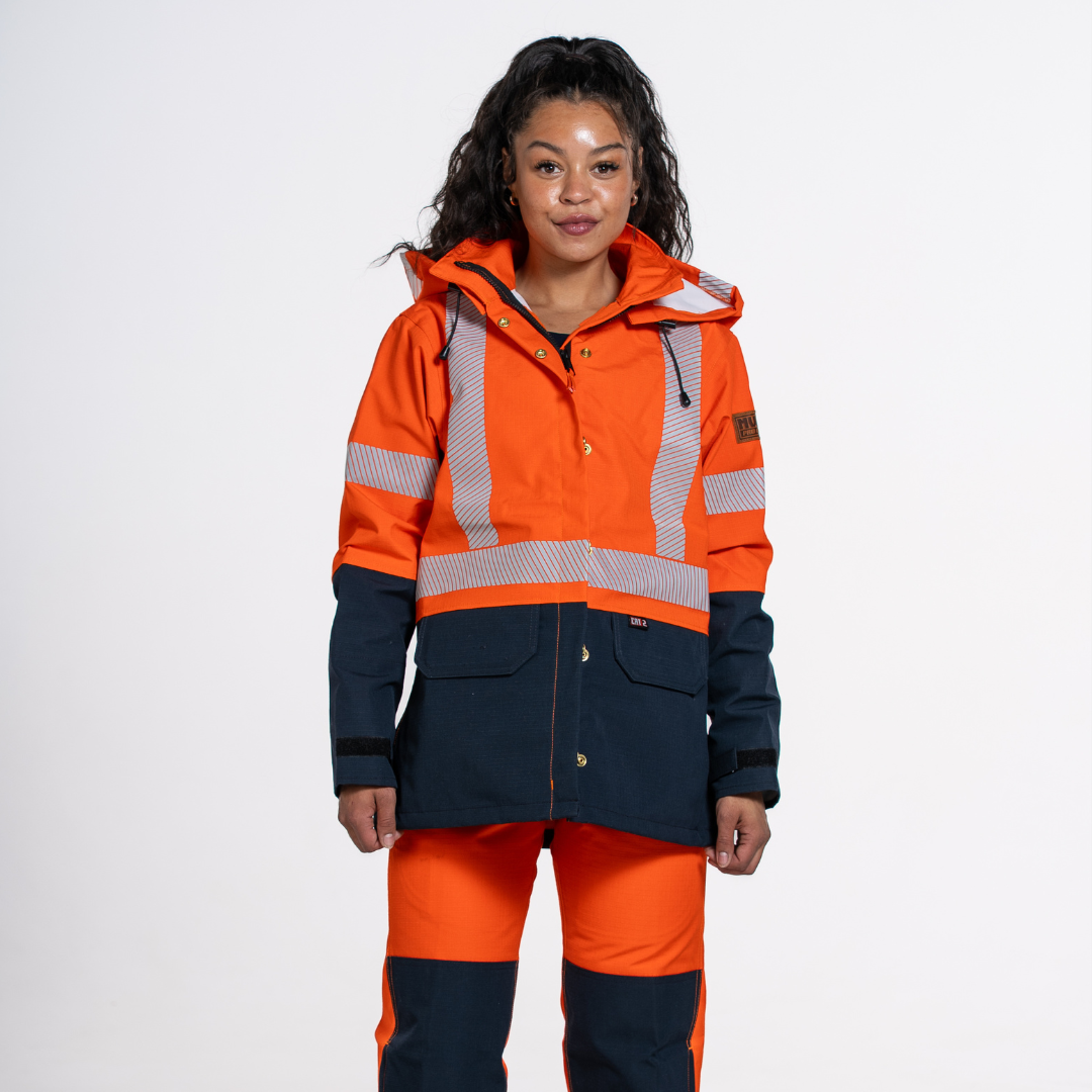 MWG STORMSHIELD Women's FR Rain Jacket. Women's FR Rain Jacket is bright orange and navy with silver reflective striping. Women's FR Rain Jacket is CAT 2 FR.