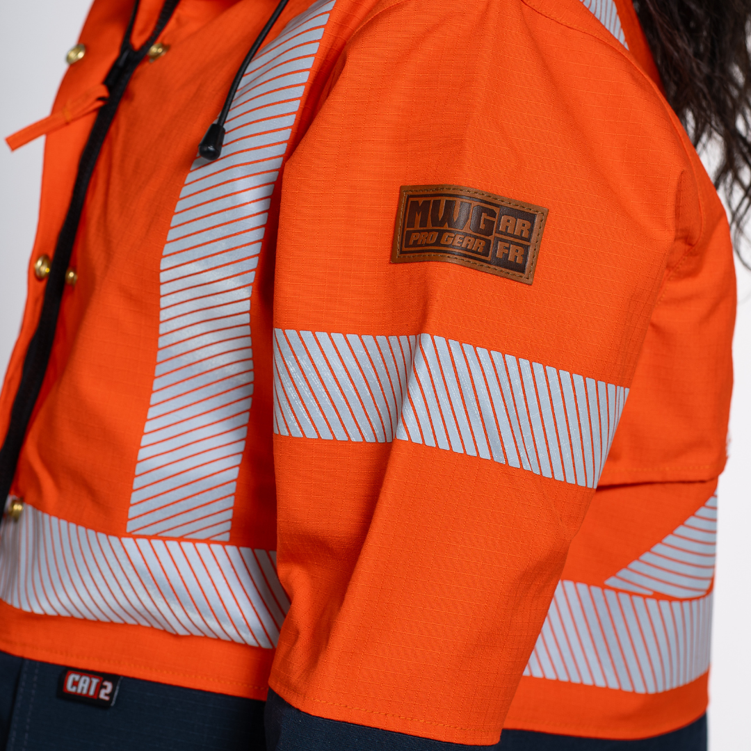 MWG STORMSHIELD Women's FR Rain Jacket. Women's FR Rain Jacket is bright orange and navy with silver reflective striping. Women's FR Rain Jacket is CAT 2 FR.