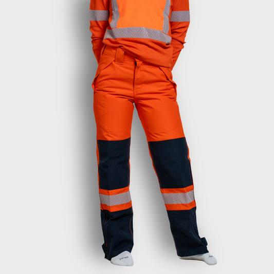 MWG STORMSHIELD Women's FR Rain Pant. Women's FR Rain Pant is bright orange and navy with silver reflective striping. Women's FR Rain Pant is CAT 2 FR.