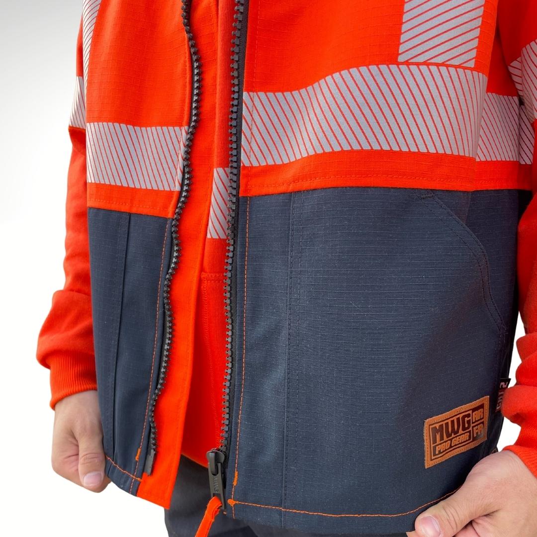 MWG STORMSHIELD Men's FR Vest. FR Vest is bright orange and navy with silver reflective for high-visibility. FR Vest is made with MWG STORMSHIELD, a flame-resistant ripstop waterproof fabric. FR Vest is made in Canada. FR Vest has a CAT 2 FR rating.