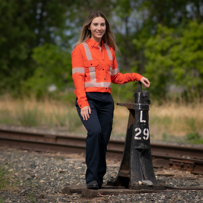 MWG COMFORT WEAVE Women's FR Shirt. Women's FR Shirt is bright orange with silver segmented reflective striping on torso and sleeves for high-visibility. Women's FR Shirt has black FR buttons, two large chest pockets with flaps, and a dress shirt collar. Women's FR Shirt is made with MWG COMFROT WEAVE, an inherently flame-resistant lightweight fabric. Women's FR Shirt wicks sweat away from the skin and breathes, perfect FR shirt for warm weather.