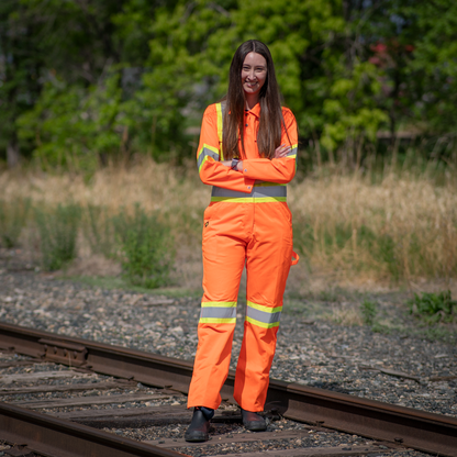 Image of MWG Women's Hi-Vis Coverall. Women's Coverall is bright orange in colour with yellow/silver/yellow reflective tape on torso, sleeves, and legs to meet high-visibility standard CSA Z96-15. Hi-Vis Coverall is a women's fit.