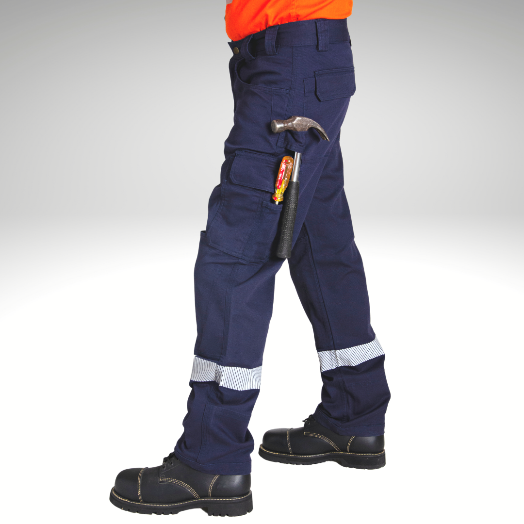 Side view of MWG FLEXGUARD FR Utility Pant. MWG FLEXGUARD is a treated FR stretch canvas. FR Utility Pant is navy with silver segmented reflective tape on lower leg. Image shows the functionality of the tool pockets and loops, showing a hammer and screwdriver sitting comfortably on left leg.