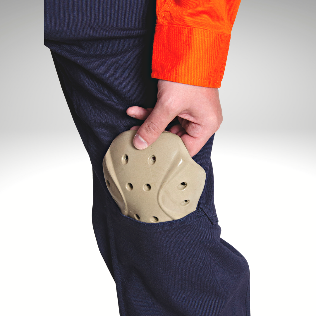 Image of P5 D30 Knee Pad sliding in to the knee pocket of the MWG FLEXGUARD FR Utility Pant. Knee pad is light beige in colour sliding in to a navy pant.