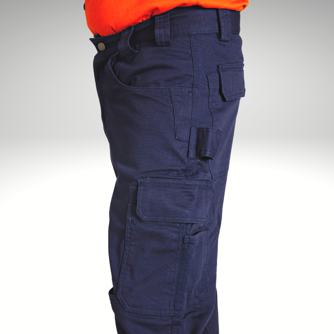 Side view of MWG FLEXGUARD FR Utility Pant. Image displays large cargo pocket, screwdriver slot, tool loop, and hip pocket. MWG FR Pant is navy in colour. MWG FLEXGUARD is a treated stretch canvas fabric.