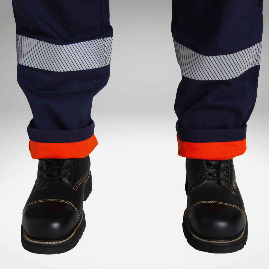 Close up image of MWG FLEXGUARD FR//AR Lined Stretch Canvas Utility Pant. Lined FR Stretch Pant is navy in colour with silver segmented reflective tape for high-visibility. Navy FR Pant has orange lining for warmth in the winter. MWG FLEXGUARD is a flame-resistant canvas.