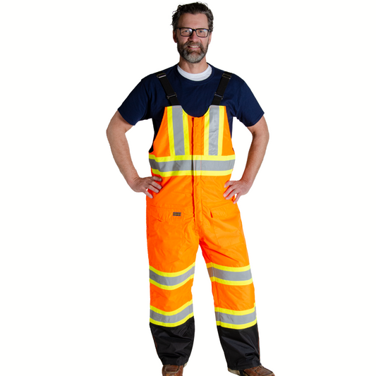 Image of Hi-Vis Insulated Bib Pant. Hi-Vis bib pant is bright orange in colour and black on lower leg, with yellow/silver/yellow reflective tape on torso and legs to meet high-visibility standard CSA Z96-15. Bib straps are black in colour. Two front pockets with flaps on upper thigh are seen in image.