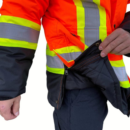 Close up of zipper on men's hi-vis jacket. Hi-Vis Jacket has a black zipper on hips for ease of movement. Hi-Vis Jacket is bright orange with yellow/silver/yellow reflective for hi-vis compliance.