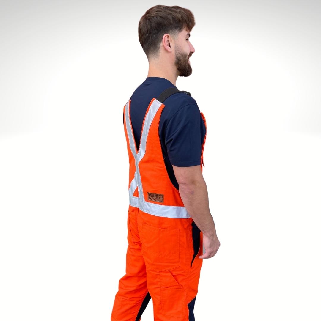 MWG RIPGUARD Men's FR Overalls with knit-lining. FR Overalls are bright orange and navy with silver reflective striping in an X pattern for high-visibility. FR Overalls are made with MWG RIPGUARD, an inherently flame-resistant ripstop fabric. FR Overalls have a warm lining for working outdoors on cold days. FR Overalls have a brown leather MWG patch on back hip.