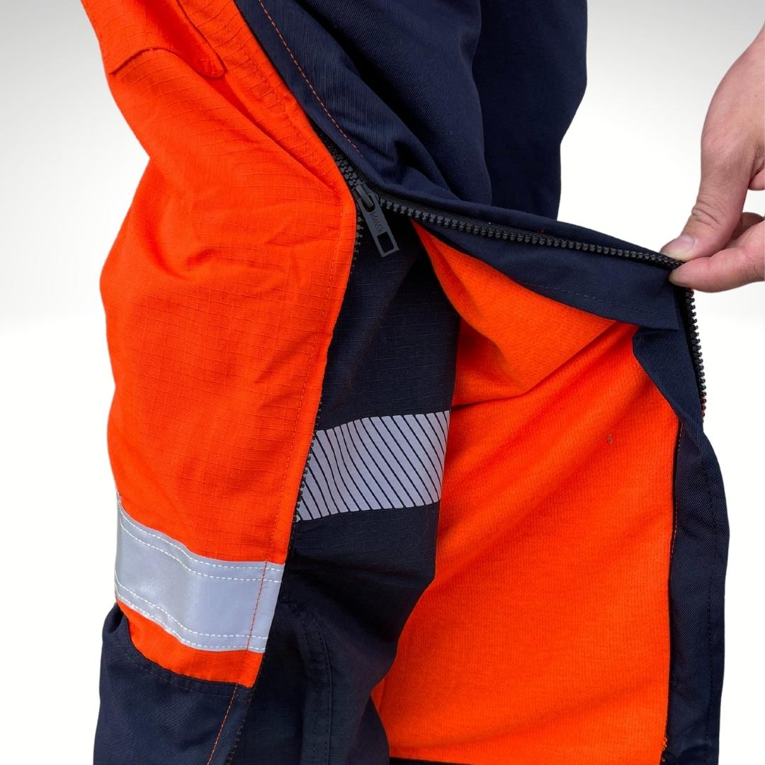 Close up image of lining in MWG RIPGUARD FR Overalls. Knit-lining is bright orange. Knit lining is made with MWG TRANSMISSION, an inherent flame-resistant fabric. Lining is designed for additional warmth on cooler days. FR Overalls have a CAT 3 FR rating.