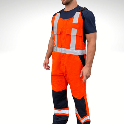 MWG RIPGUARD Men's FR Bib Overall. Men's FR Overall is bright orange and navy with silver reflective striping on torso and legs for high-visibility. FR Overalls have two chest pockets with flaps, two FR leg zippers, and a front FR zipper. FR Overalls have black FR adjustable shoulder straps. FR Overalls are made with MWG RIPGUARD, a flame-resistant ripstop fabric. FR Overalls have a CAT 2 FR rating.