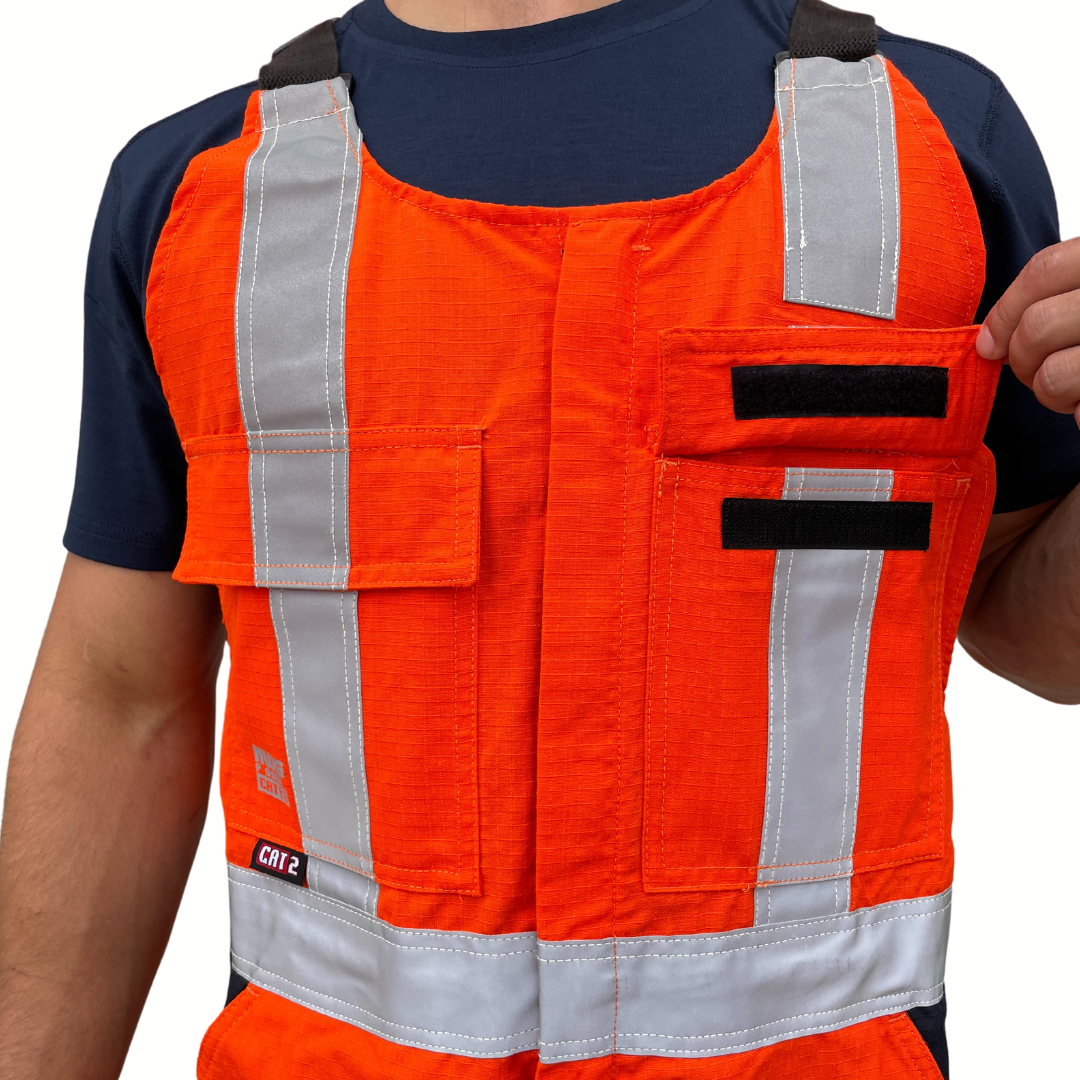 MWG RIPGUARD Men's FR Bib Overall. Men's FR Overall is bright orange and navy with silver reflective striping on torso and legs for high-visibility. FR Overalls have two chest pockets with flaps, two FR leg zippers, and a front FR zipper. FR Overalls have black FR adjustable shoulder straps. FR Overalls are made with MWG RIPGUARD, a flame-resistant ripstop fabric. FR Overalls have a CAT 2 FR rating.