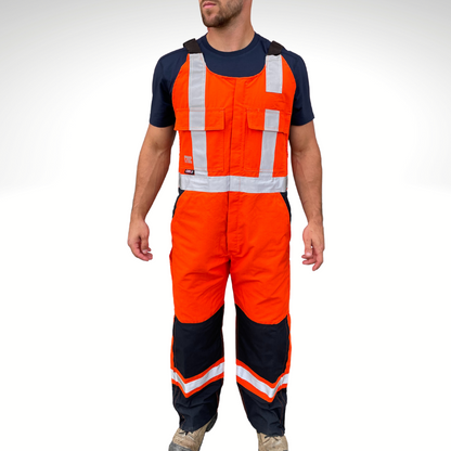 MWG RIPGUARD Men's FR Bib Overall. Men's FR Overall is bright orange and navy with silver reflective striping on torso and legs for high-visibility. FR Overalls have two chest pockets with flaps, two FR leg zippers, and a front FR zipper. FR Overalls have black FR adjustable shoulder straps. FR Overalls are made with MWG RIPGUARD, a flame-resistant ripstop fabric. FR Overalls have a CAT 2 FR rating.