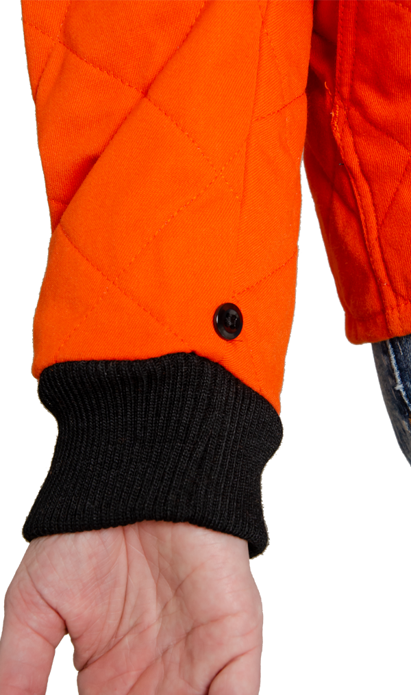 Close up image of small black button on women's FR freezer jacket to attach to outer shell for 3-in-1 system jacket.