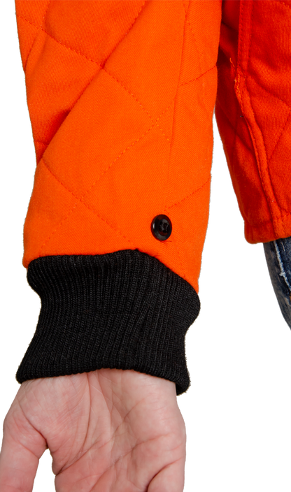 Close up image of small black button on women's FR freezer jacket to attach to outer shell for 3-in-1 system jacket.